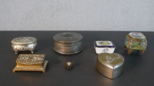 A collection of seven trinket boxes, including chamfered glass and brass box, a repousse pewter