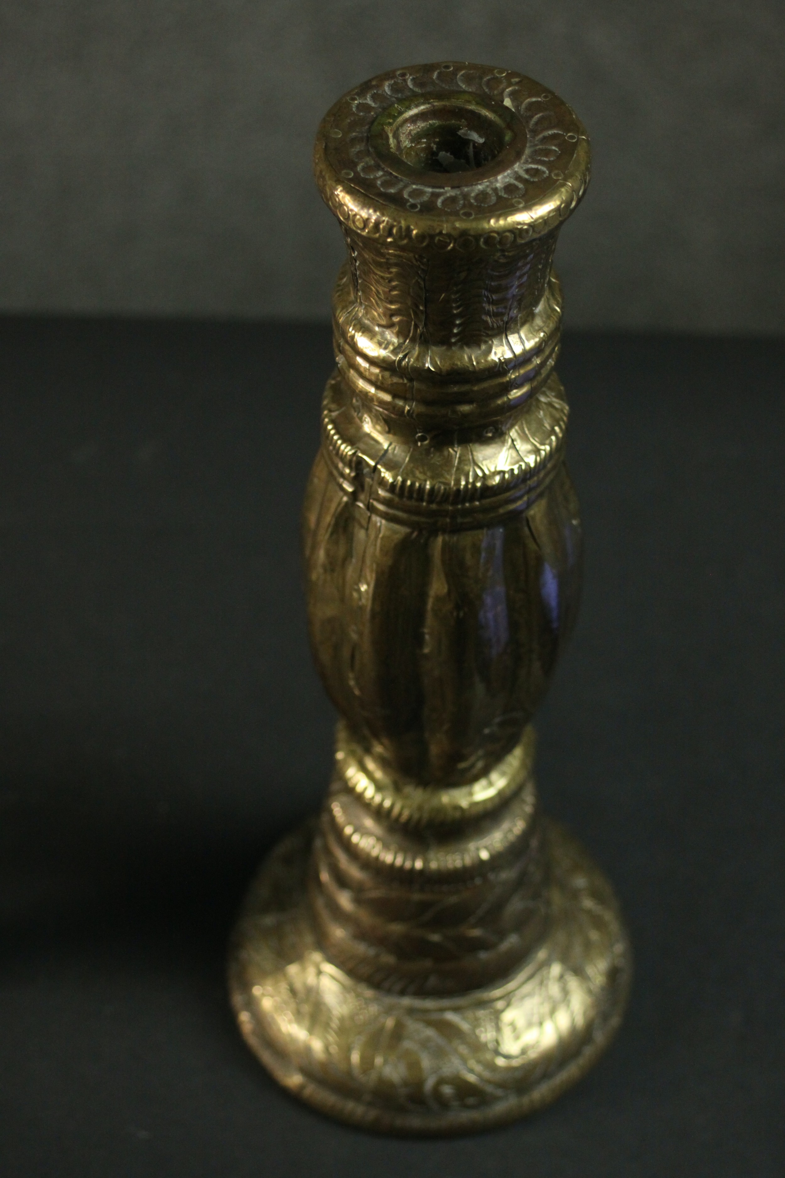 Three Indian brass items, comprising an ornately decorated candlestick, another candlestick, and a - Image 3 of 6