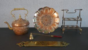 A collection of brass and copper, including a brass door plate, copper floral design plate and