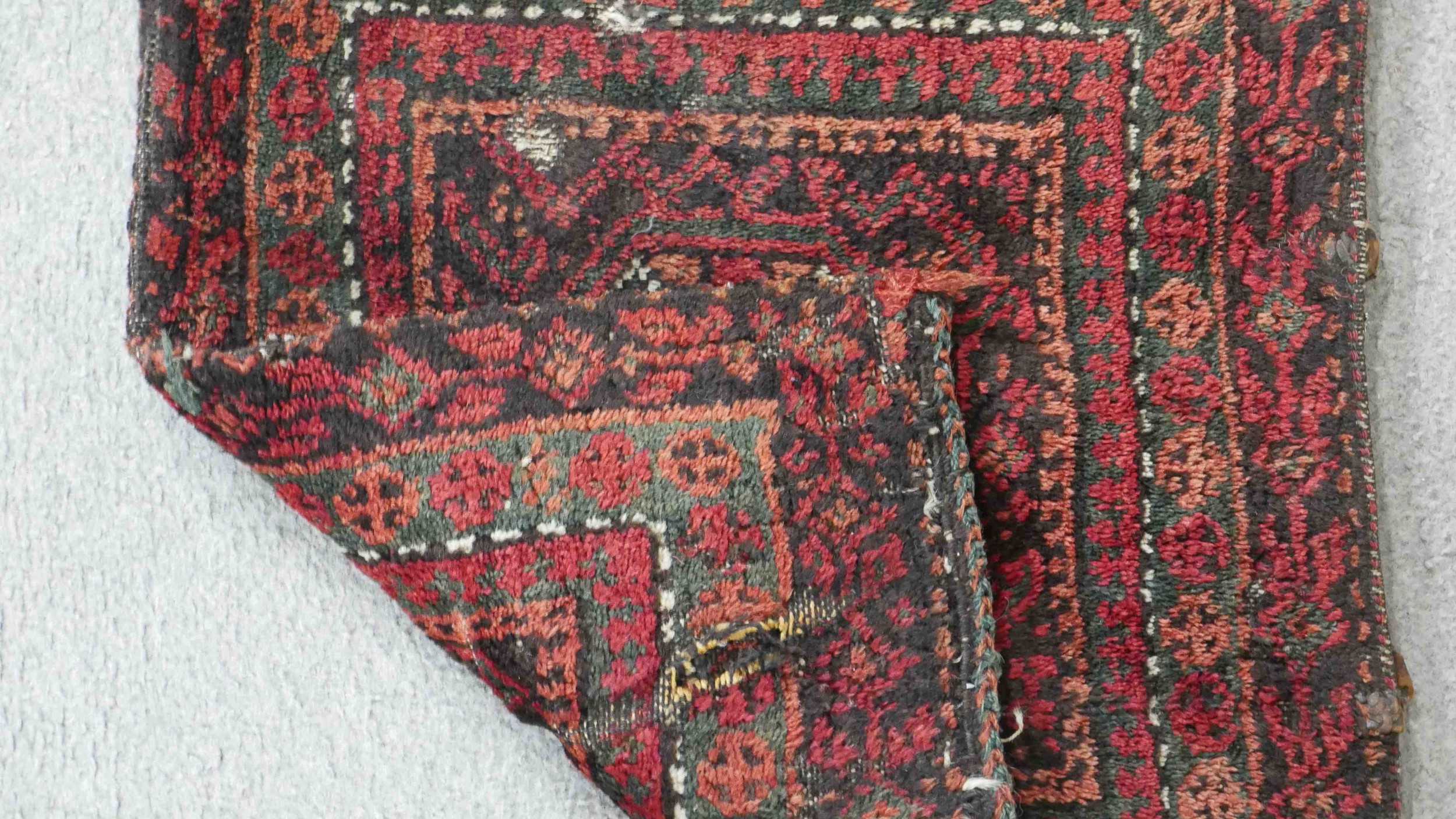 A Persian Belouch saddlebag with central octagonal medallion in multiple borders. L.45 W.41cm. - Image 4 of 4