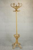 A late 20th century bentwood hat and coat stand, with six S shaped hooks, on splayed feet joined