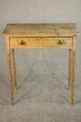 A 19th century pine side table with a rectangular top and a single drawer with brass knob handles,