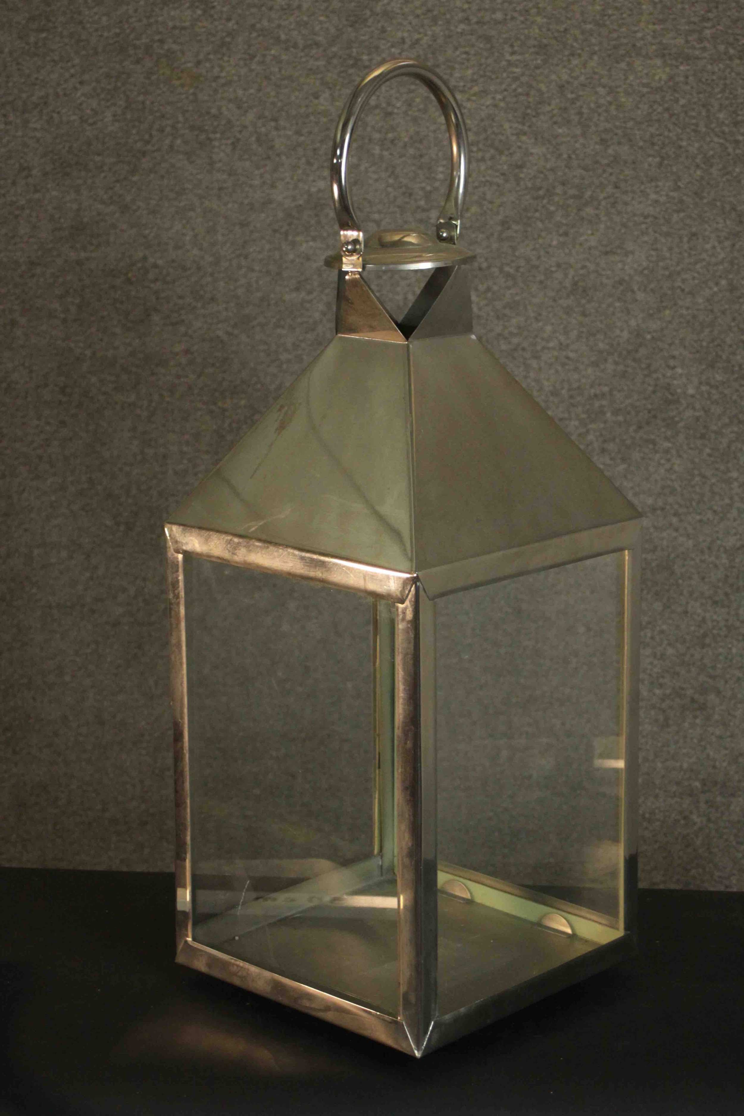 A contemporary nickel plated storm lantern, with a loop handle above a sloped top, with four - Image 5 of 5