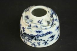 A 19th century blue and white porcelain hand painted brush pot with relief dragon around the rim.