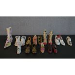 A collection of miniature shoes, including a pair of silk stilettos, three porcelain boots and other
