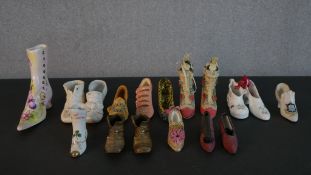 A collection of miniature shoes, including a pair of silk stilettos, three porcelain boots and other