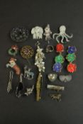 A collection of costume jewellery, including diamante brooches, a silver sweetheart brooch, a pair