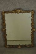 A 19th century Rococo revival mirror, the carved wood and gesso frame adorned with C and S