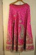 A vintage heavily embroidered and beaded pink silk Indian wedding skirt embellished with sequins