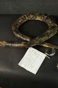 A collection of serpent design items, including a pair of hand painted snake design trinket trays, a