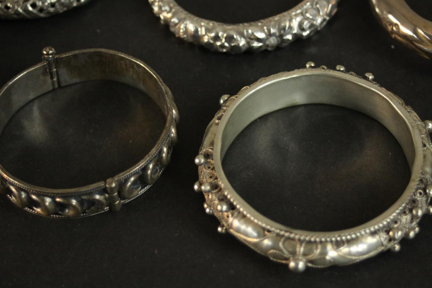 A collection of five white metal Oriental bangles and three silver plated bangles. A pair of Chinese - Image 6 of 8