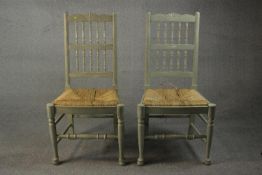 A pair of grey painted Lancashire side chairs, with spindle back and rush seat, on turned legs