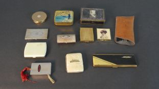 A collection of vintage compacts, cigarette holders and a pair of leather cased gold plated