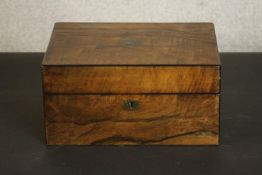 A 19th century figured walnut sewing box, the interior with a buttoned silk lid and a fitted tray.