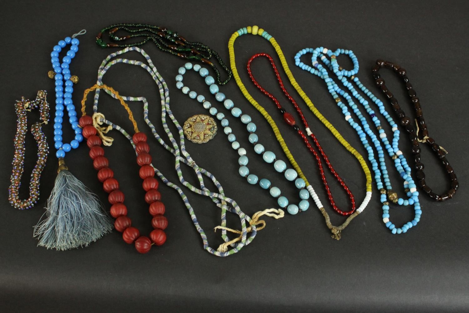 A collection of vintage and African glass trade beads and necklaces, including early 20th century
