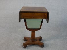 A Victorian walnut sewing table, with two drop leaves, a single fitted drawer over a green