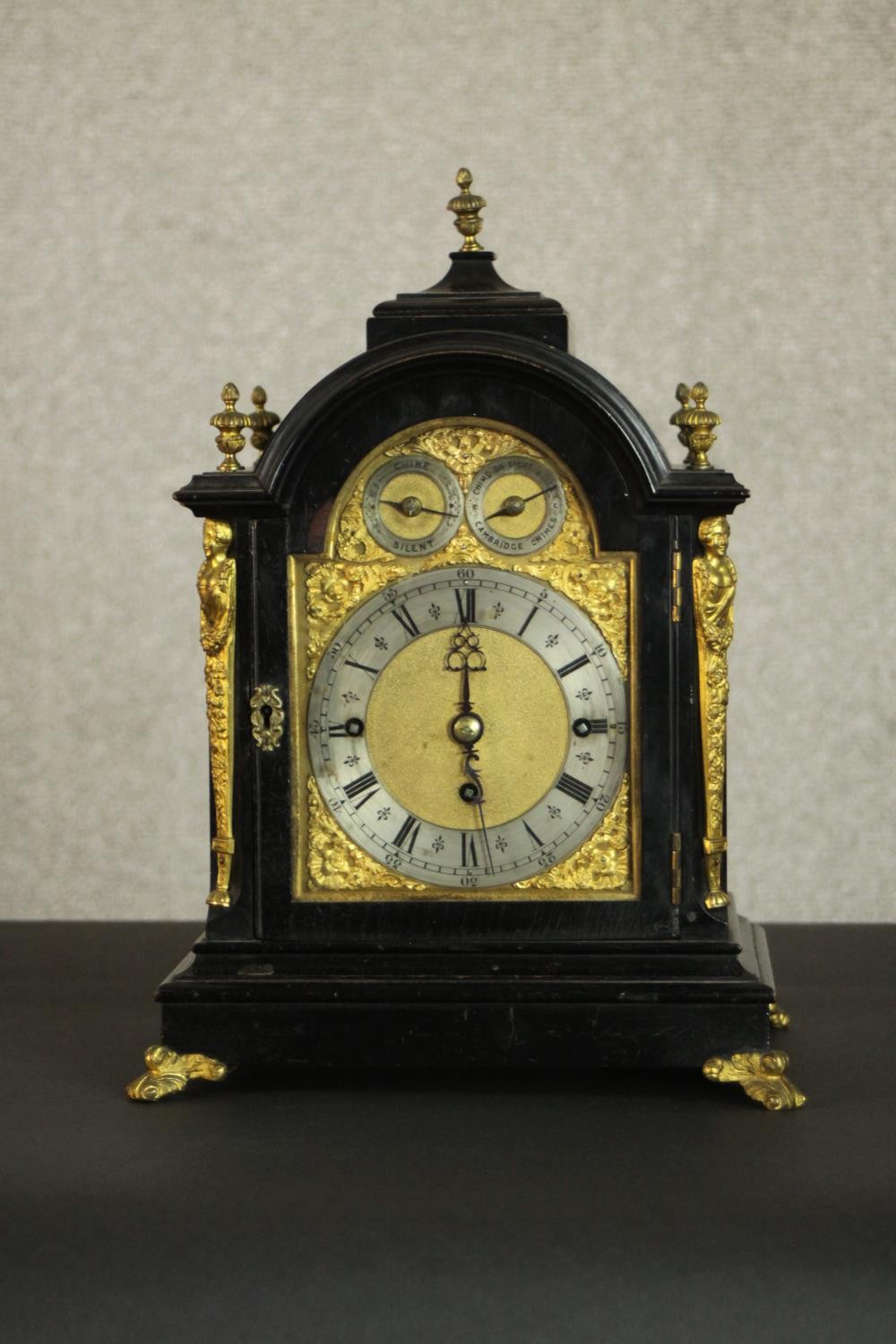 A late 19th Century George III style ebonised cased bracket clock, the arch dial incorporating a