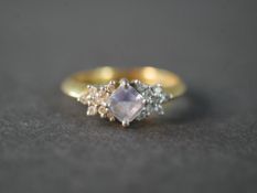 An 18 carat yellow gold and platinum tanzanite and diamond dress ring, set to centre with a square