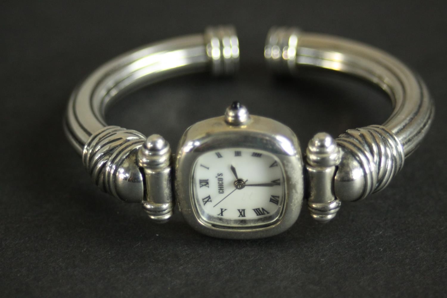 A collection of silver bangles, a silver bangle watch and a tortoiseshell and silver articulated - Image 6 of 9