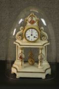A Late 19th century French alabaster portico clock, under a glass dome, the circular enamelled