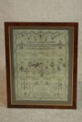 A framed and glazed 19th century embroidered sampler with flowers, birds and a poem by Mary,