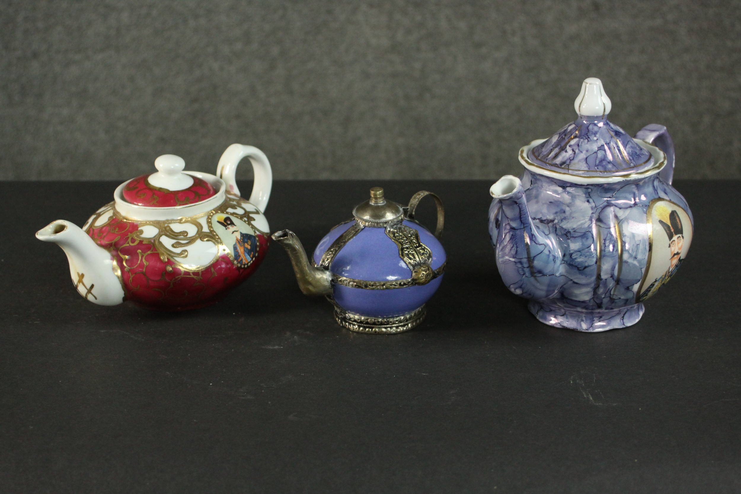 Three porcelain and pottery teapots, two made for the Persian market with portraits of Naser al-