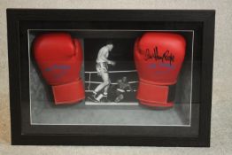 A pair of framed and glazed boxing gloves signed by Henry Cooper. H.50 W.73 D.13cm