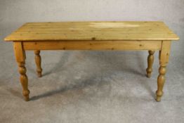 A Victorian style pine kitchen table, the rectangular top with rounded corners on turned legs. H.