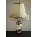 A Japanese porcelain vase table lamp with blue and white foliate designs and foliate reserves,