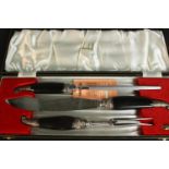 A leather cased Dunhill buffalo horn and silver plate carving set. H.5 L.45 D.16cm.