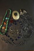 A collection of gemstone necklaces and other jewellery. A graduated carved malachite bead
