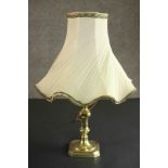 A brass table lamp converted from a candlestick, with a cream coloured shade. H.44 Dia.30cm.