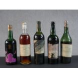 A collection of five bottles of vintage wine and port.
