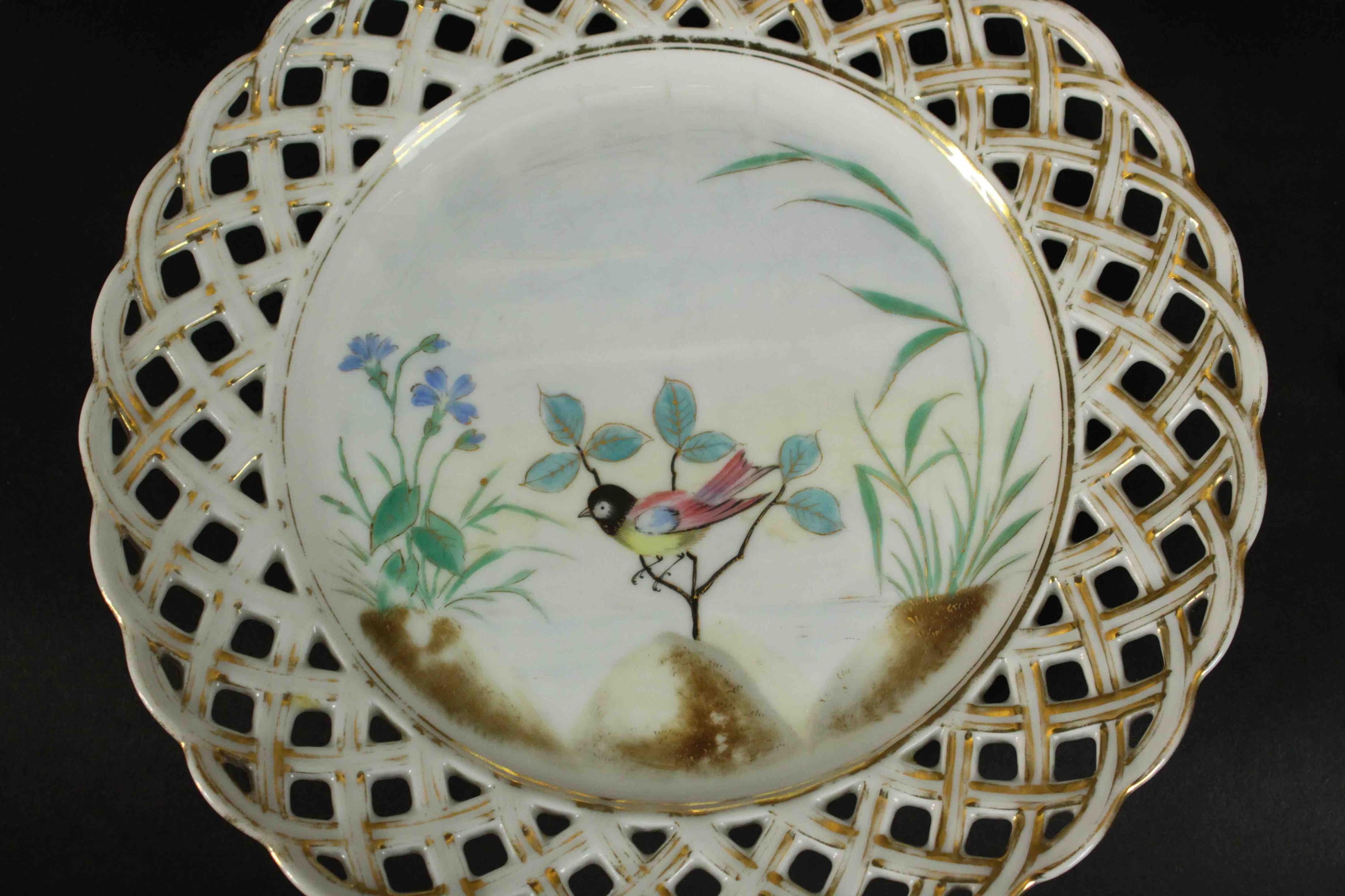 A set of eleven 19th century hand painted porcelain plates with pierced gilded lattice work rims and - Image 3 of 6