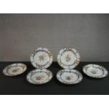 A set of six 19th century Wedwood Pearlware plates, decorated with flowers and gilded detail,