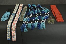 A collection of seven South American beaded belts and other jewellery. L.100cm.