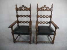 A pair of Spanish walnut ladder back carvers, the back carved with C scrolls over a black leather