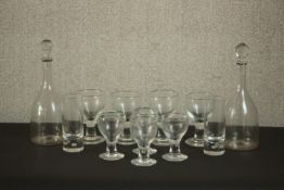 A set of four large heavy wine glasses and four smaller ones along with a pair of blown glass