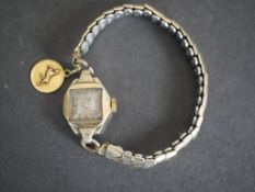 A ladies vintage cocktail watch with 18 carat yellow gold zodiac charm. Stamped 750.