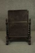 An early 19th century mahogany toilet mirror, missing the mirror plate, on barley twist supports