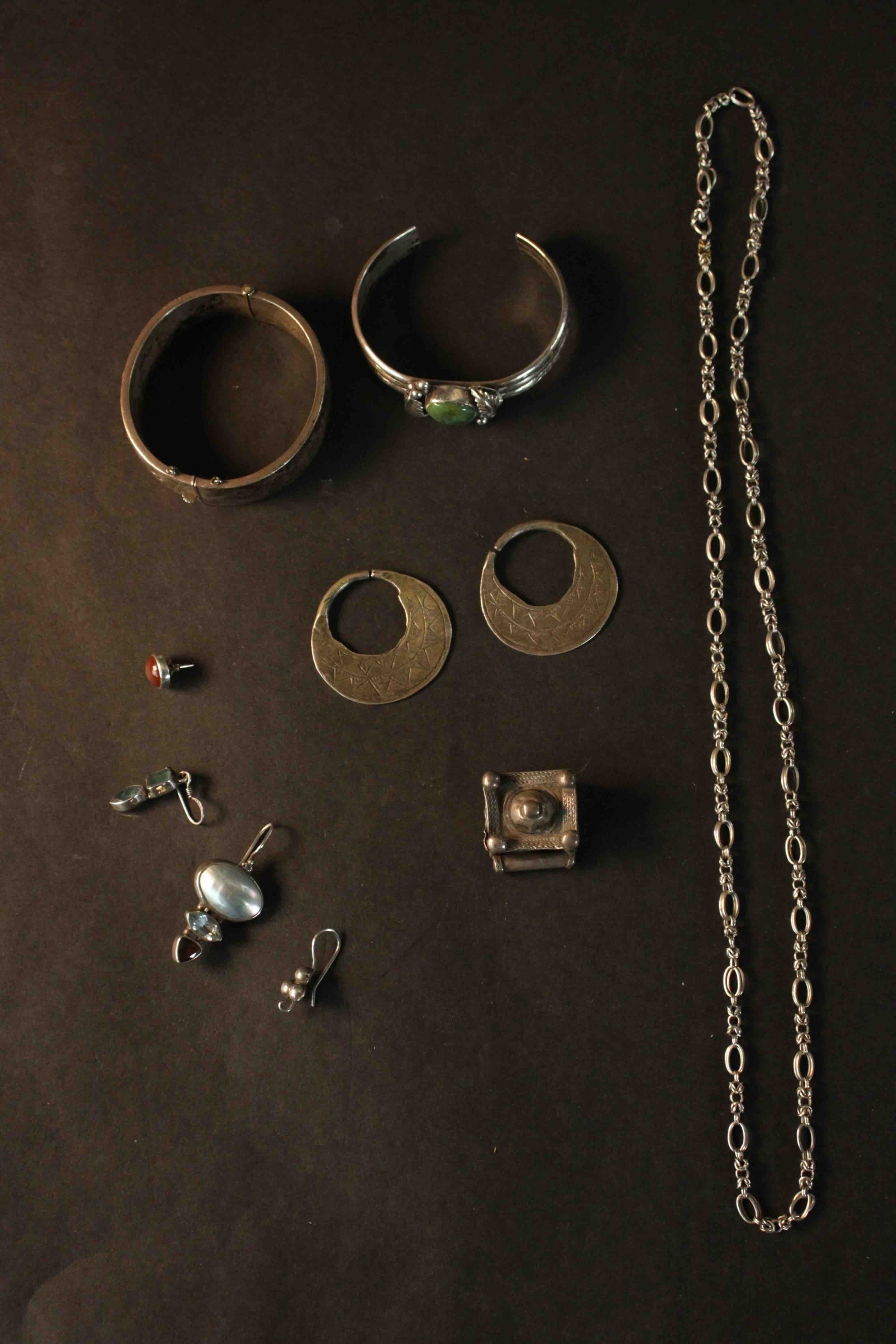 A collection of Oriental silver jewellery, including a engraved silver bangle with push catch and