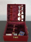 A boxed Asprey of London wine red leather travelling drinks case with four frosted glass