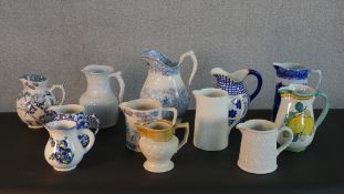 A collection of ten jugs, including a Doulton Lambeth tobacco jug. H.26cm (largest)