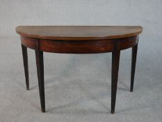 A George III mahogany demi-lune console table on square section tapering legs. H.74 W.129 D.64cm