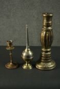 Three Indian brass items, comprising an ornately decorated candlestick, another candlestick, and a