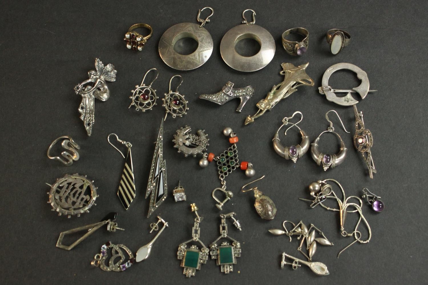 A large collection of silver and gemset jewellery, including amethyst and silver earrings, a pair of