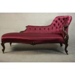 A Victorian show wood spoon back chaise longue with a button back upholstered in purple satin and