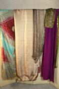 A collection of vintage fabric and textiles, including several vintage silk saris (pale peach one