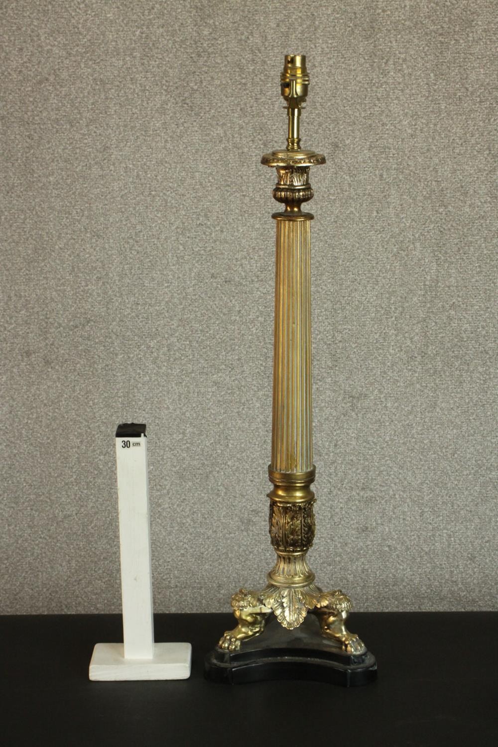 A 20th century brass table lamp of columnar form with a cast tri-form base with lion paw feet. H. - Image 2 of 5