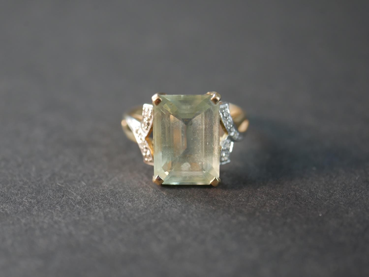 A 9 carat topaz and diamond dress ring, set to centre with a rectangular emerald cut topaz with an - Image 2 of 4